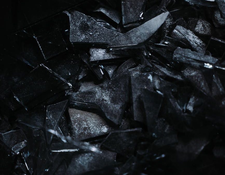 fragments of broken glass on a black surface