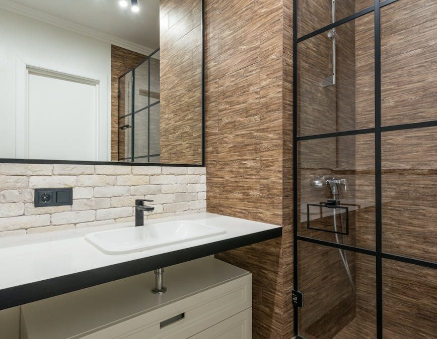 sink near shower cabin in bathroom